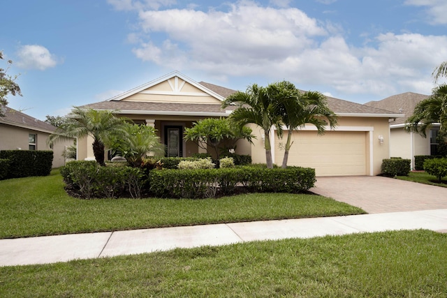 10295 SW Waterway Ln, Port Saint Lucie, FL 34987 - view of front facade with decorative driveway, an attached garage, a front lawn, stucco siding, and a shingled roof