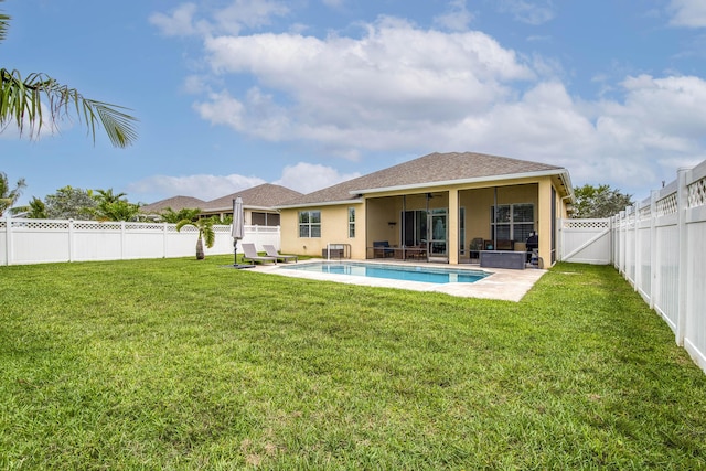 10295 SW Waterway Ln, Port Saint Lucie, FL 34987 - back of property with a fenced backyard, ceiling fan, a patio area, stucco siding, and a hot tub