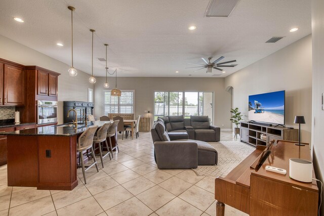 10295 SW Waterway Ln, Port Saint Lucie, FL 34987 - living area with light tile patterned floors, recessed lighting, ceiling fan, and arched walkways