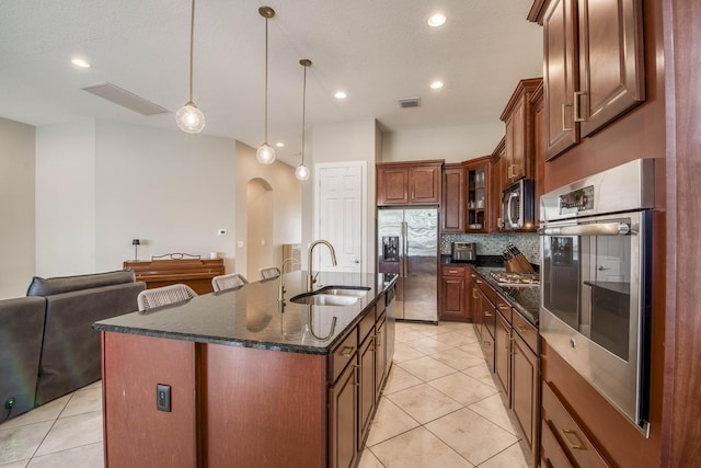 10295 SW Waterway Ln, Port Saint Lucie, FL 34987 - kitchen featuring stainless steel appliances, arched walkways, light tile patterned floors, decorative backsplash, and recessed lighting