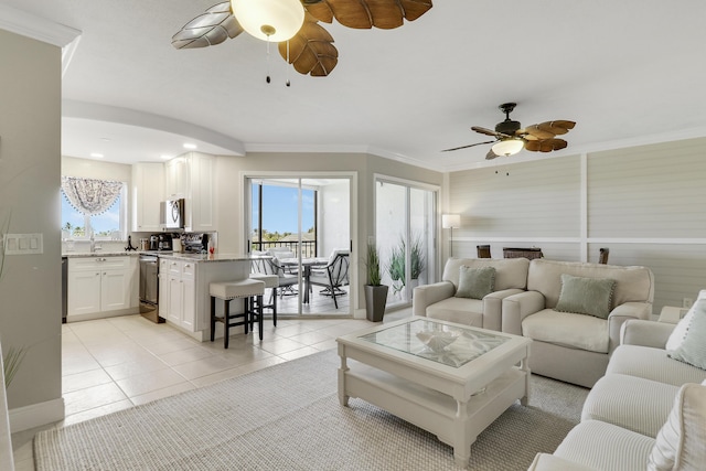 275 Palm Ave Unit A406, Jupiter, FL 33477 - living area with ceiling fan, healthy amount of natural light, light tile patterned floors, crown molding, and a fireplace