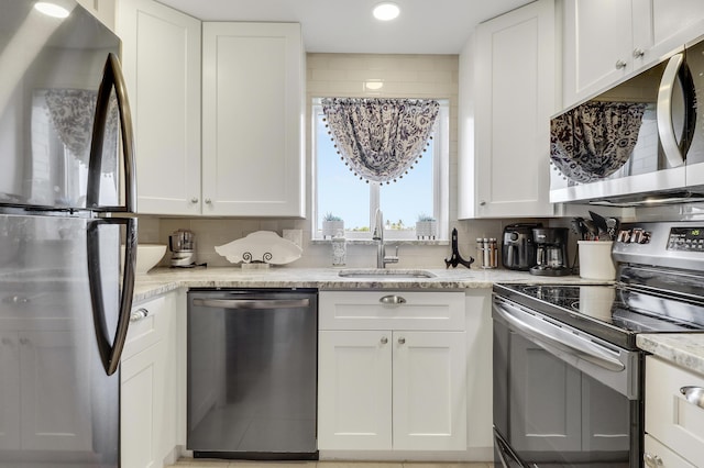 275 Palm Ave Unit A406, Jupiter, FL 33477 - kitchen featuring appliances with stainless steel finishes, white cabinets, and recessed lighting