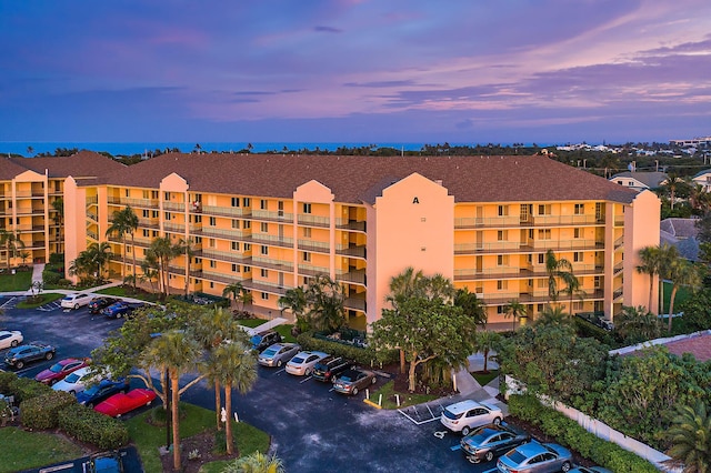 275 Palm Ave Unit A406, Jupiter, FL 33477 - property at dusk featuring a view of apartment building / complex and uncovered parking