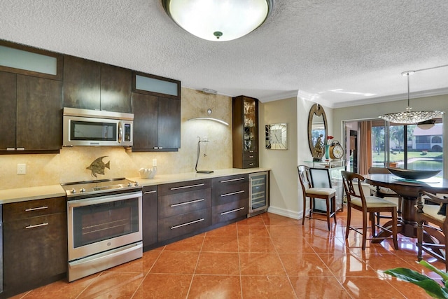 326 Knotty Pine Cir Unit C-1, Greenacres, FL 33463 - kitchen with stainless steel appliances, beverage cooler, a textured ceiling, light countertops, and dark brown cabinetry