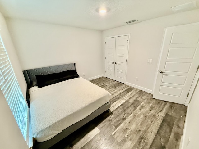4480 SW Jaunt Rd, Port Saint Lucie, FL 34953 - bedroom with wood finished floors, baseboards, and a closet