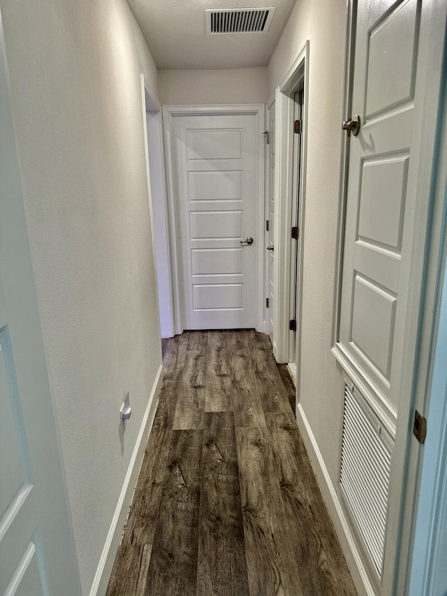 4480 SW Jaunt Rd, Port Saint Lucie, FL 34953 - hallway with dark wood-style flooring and baseboards