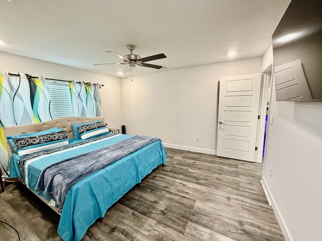 4480 SW Jaunt Rd, Port Saint Lucie, FL 34953 - bedroom featuring wood finished floors, baseboards, a ceiling fan, and a textured ceiling
