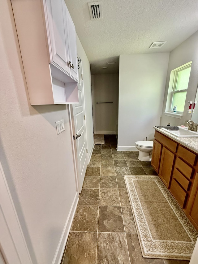 4480 SW Jaunt Rd, Port Saint Lucie, FL 34953 - bathroom featuring toilet, vanity, baseboards, and a textured ceiling