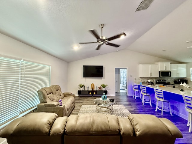 4480 SW Jaunt Rd, Port Saint Lucie, FL 34953 - living room featuring dark wood-style flooring, vaulted ceiling, ceiling fan, and baseboards