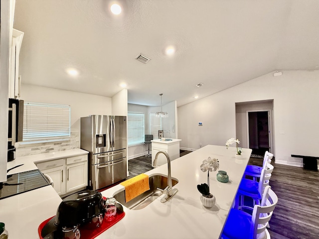 4480 SW Jaunt Rd, Port Saint Lucie, FL 34953 - kitchen with stainless steel fridge with ice dispenser, dark wood-style floors, backsplash, a center island, and recessed lighting