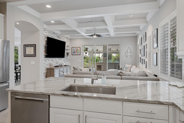 1439 Barlow Ct, Palm Beach Gardens, FL 33410 - kitchen featuring open floor plan, appliances with stainless steel finishes, a sink, beamed ceiling, and recessed lighting