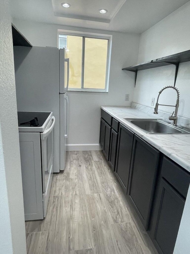 740 11th St Unit 3A, Miami Beach, FL 33139 - kitchen featuring white range with electric stovetop, a sink, open shelves, light wood-style flooring, and baseboards