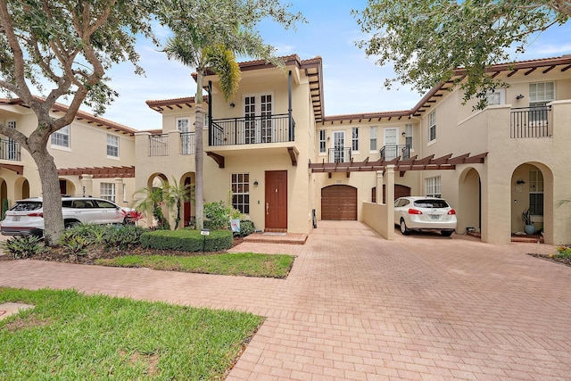 2788 Eagle Rock Cir Unit 3, West Palm Beach, FL 33411 - view of front facade with driveway, stucco siding, a garage, a tile roof, and a balcony