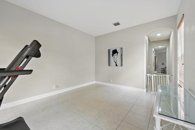 2788 Eagle Rock Cir Unit 3, West Palm Beach, FL 33411 - exercise room with arched walkways, baseboards, and light tile patterned floors