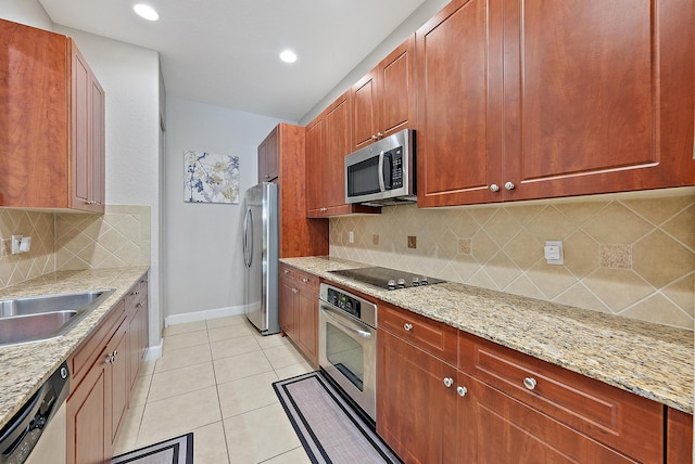 2788 Eagle Rock Cir Unit 3, West Palm Beach, FL 33411 - kitchen with appliances with stainless steel finishes, baseboards, tasteful backsplash, light tile patterned flooring, and recessed lighting