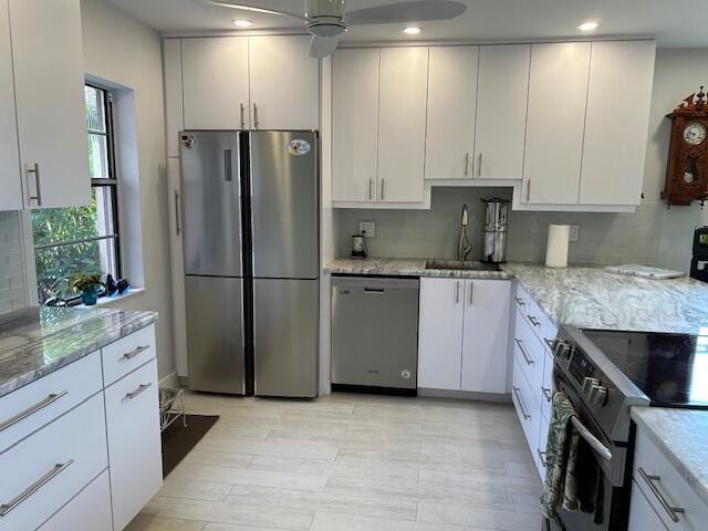 100 Lake Terry Dr, West Palm Beach, FL 33411 - kitchen with appliances with stainless steel finishes, a sink, ceiling fan, white cabinetry, and light stone countertops