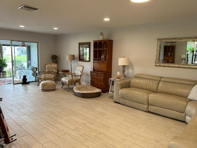 100 Lake Terry Dr, West Palm Beach, FL 33411 - living room featuring light wood-type flooring and recessed lighting