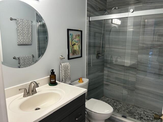100 Lake Terry Dr, West Palm Beach, FL 33411 - full bath with vanity, a shower stall, and toilet