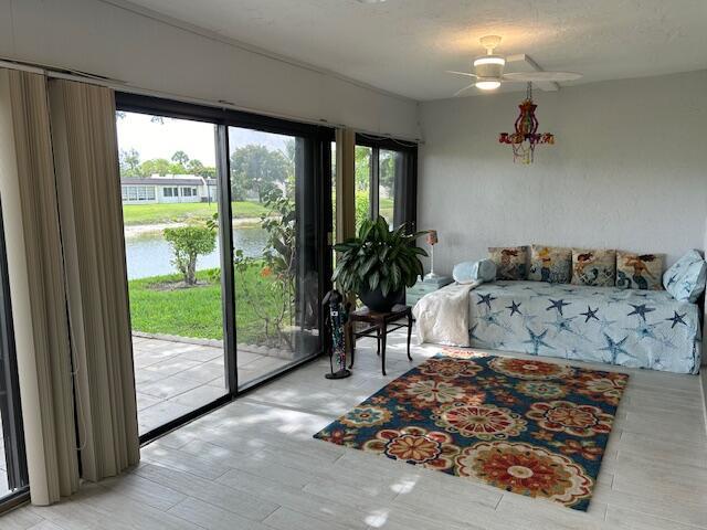 100 Lake Terry Dr, West Palm Beach, FL 33411 - bedroom featuring a water view, access to exterior, and ceiling fan