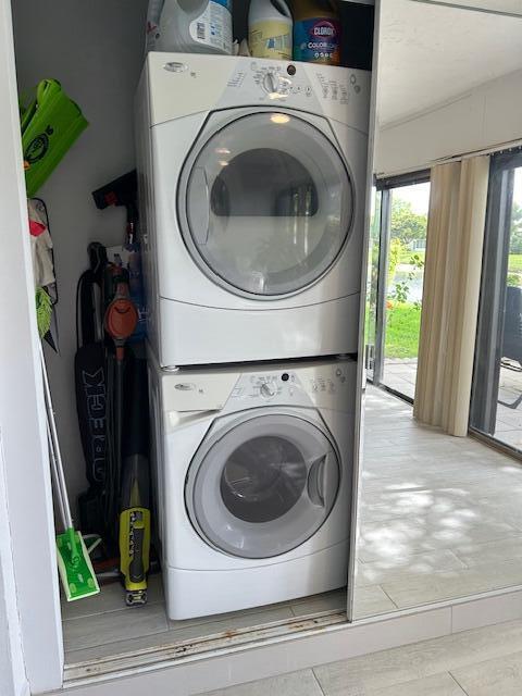 100 Lake Terry Dr, West Palm Beach, FL 33411 - laundry area featuring stacked washer / drying machine and light tile patterned floors