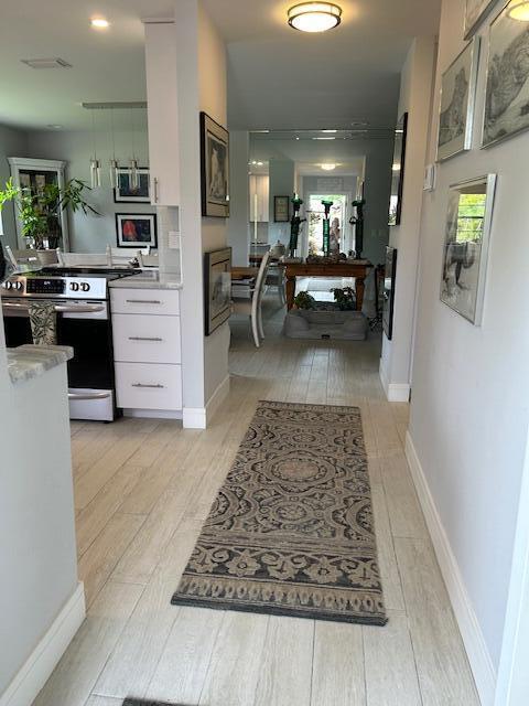 100 Lake Terry Dr, West Palm Beach, FL 33411 - hall featuring light wood finished floors