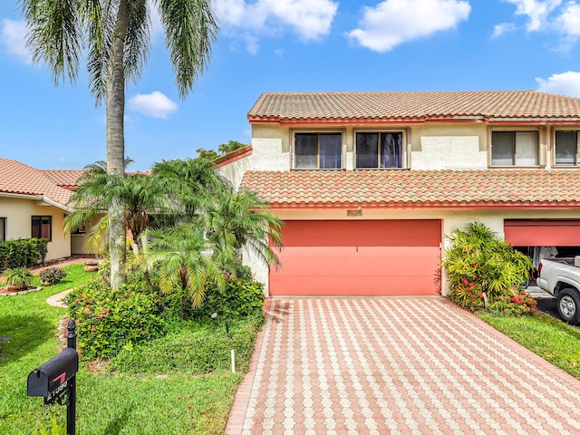 21596 Magdalena Ter, Boca Raton, FL 33433 - mediterranean / spanish home with an attached garage, a tiled roof, stucco siding, and driveway