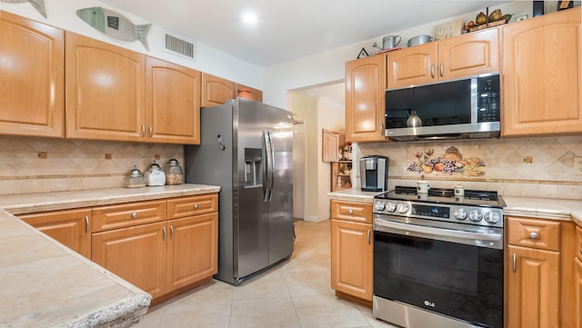 21596 Magdalena Ter, Boca Raton, FL 33433 - kitchen featuring stainless steel appliances, light tile patterned flooring, backsplash, and tile counters
