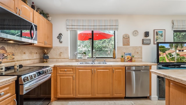 21596 Magdalena Ter, Boca Raton, FL 33433 - kitchen featuring stainless steel appliances, a sink, light countertops, and backsplash