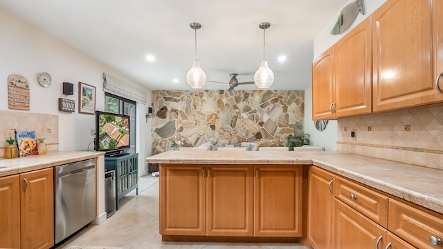 21596 Magdalena Ter, Boca Raton, FL 33433 - kitchen with stainless steel dishwasher, backsplash, a peninsula, light countertops, and pendant lighting