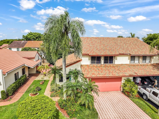 21596 Magdalena Ter, Boca Raton, FL 33433 - view of front facade with a tiled roof, stucco siding, an attached garage, and driveway