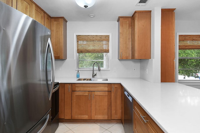 2600 SE Ocean Blvd Unit S15, Stuart, FL 34996 - kitchen featuring stainless steel appliances, brown cabinetry, and plenty of natural light