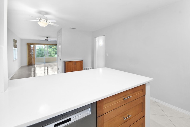 2600 SE Ocean Blvd Unit S15, Stuart, FL 34996 - kitchen featuring a ceiling fan, light countertops, stainless steel dishwasher, light tile patterned flooring, and brown cabinetry