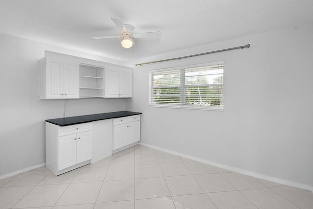 2600 SE Ocean Blvd Unit S15, Stuart, FL 34996 - kitchen featuring a ceiling fan, open shelves, dark countertops, and white cabinetry
