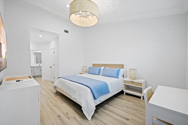 402 Sea Oats Dr Unit F, Juno Beach, FL 33408 - bedroom featuring crown molding, light wood-type flooring, recessed lighting, baseboards, and connected bathroom