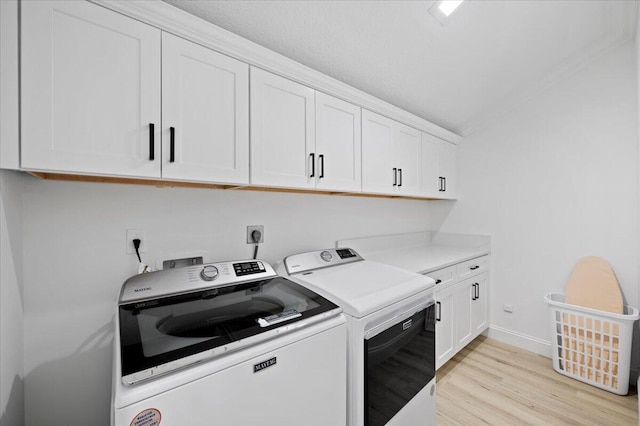 402 Sea Oats Dr Unit F, Juno Beach, FL 33408 - washroom featuring cabinet space, washing machine and dryer, light wood finished floors, and baseboards