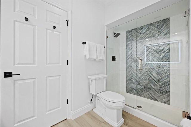 402 Sea Oats Dr Unit F, Juno Beach, FL 33408 - bathroom with toilet, a shower stall, wood finished floors, and baseboards