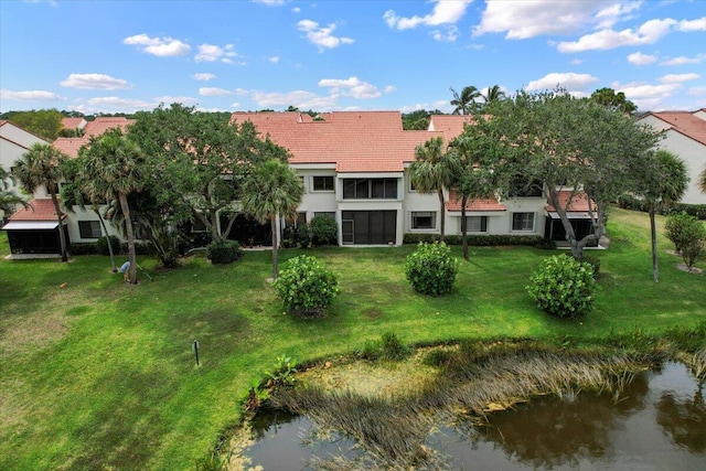 402 Sea Oats Dr Unit F, Juno Beach, FL 33408 - back of house featuring a tile roof, a yard, and stucco siding