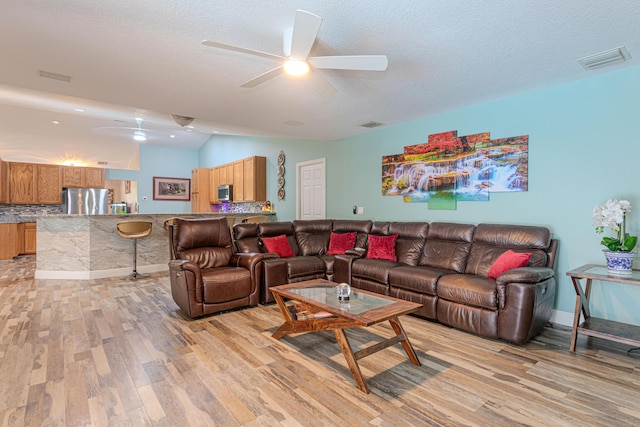 16330 Wiltshire Dr E, Loxahatchee, FL 33470 - living room with light wood finished floors, ceiling fan, and a textured ceiling