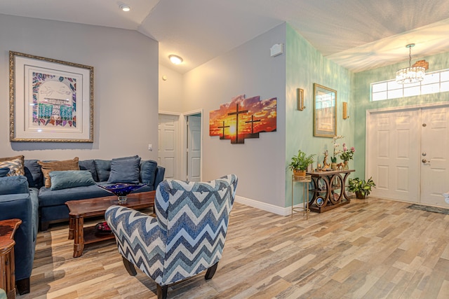 16330 Wiltshire Dr E, Loxahatchee, FL 33470 - living area with light wood-type flooring, a chandelier, and vaulted ceiling
