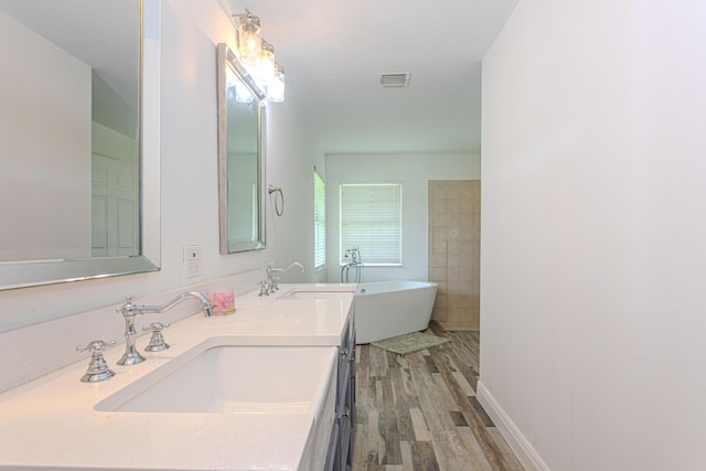 16330 Wiltshire Dr E, Loxahatchee, FL 33470 - full bathroom featuring a soaking tub, double vanity, and wood finished floors