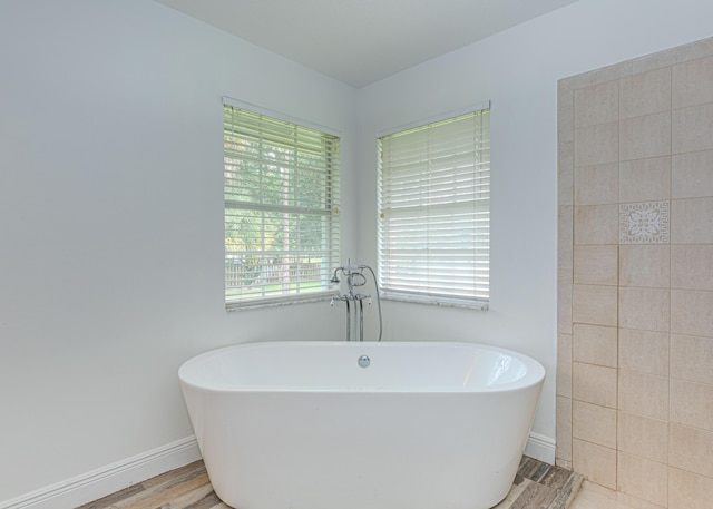 16330 Wiltshire Dr E, Loxahatchee, FL 33470 - bathroom featuring a freestanding bath and wood finished floors