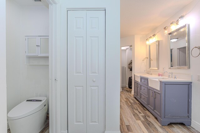 16330 Wiltshire Dr E, Loxahatchee, FL 33470 - bathroom featuring a closet, double vanity, and wood finished floors