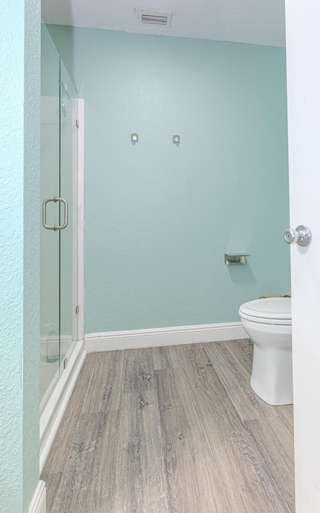 16330 Wiltshire Dr E, Loxahatchee, FL 33470 - full bath with wood finished floors, a shower stall, and a textured wall
