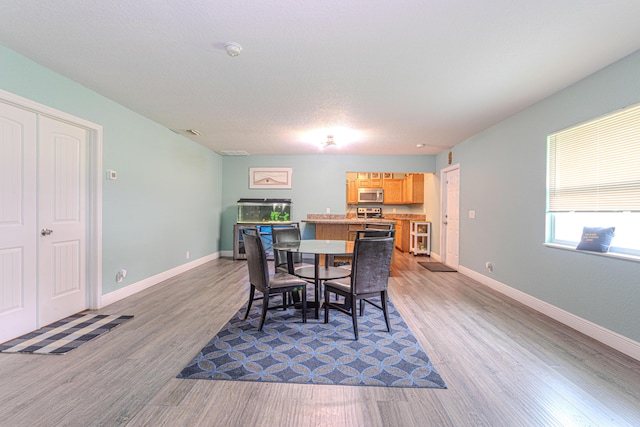 16330 Wiltshire Dr E, Loxahatchee, FL 33470 - dining space featuring wood finished floors and baseboards