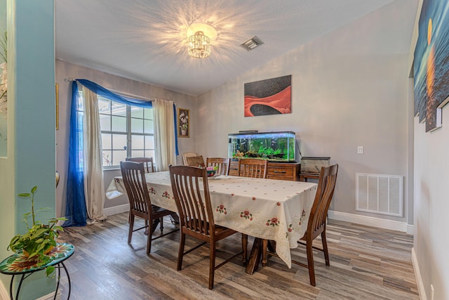 16330 Wiltshire Dr E, Loxahatchee, FL 33470 - dining space featuring wood finished floors, lofted ceiling, and a chandelier