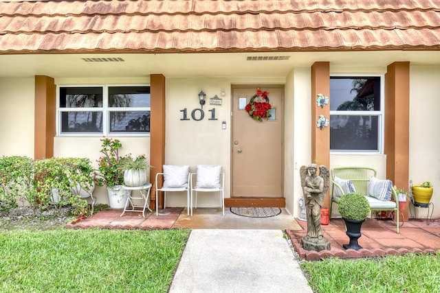 5780 W Fernley Dr Unit 101, West Palm Beach, FL 33415 - doorway to property with stucco siding and a tiled roof
