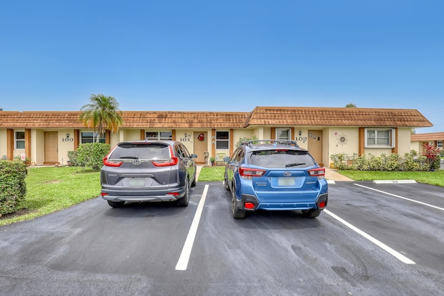 5780 W Fernley Dr Unit 101, West Palm Beach, FL 33415 - townhome / multi-family property featuring uncovered parking, stucco siding, and a front lawn