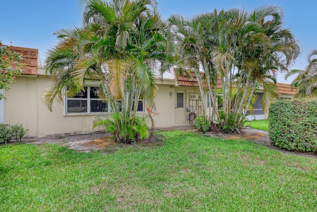 5780 W Fernley Dr Unit 101, West Palm Beach, FL 33415 - back of property featuring stucco siding and a yard