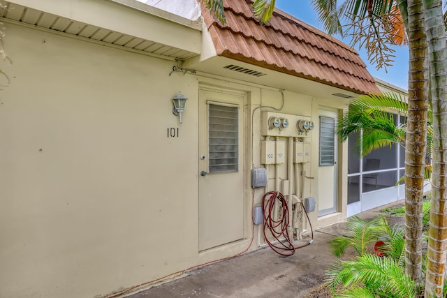 5780 W Fernley Dr Unit 101, West Palm Beach, FL 33415 - doorway to property with a tiled roof and stucco siding