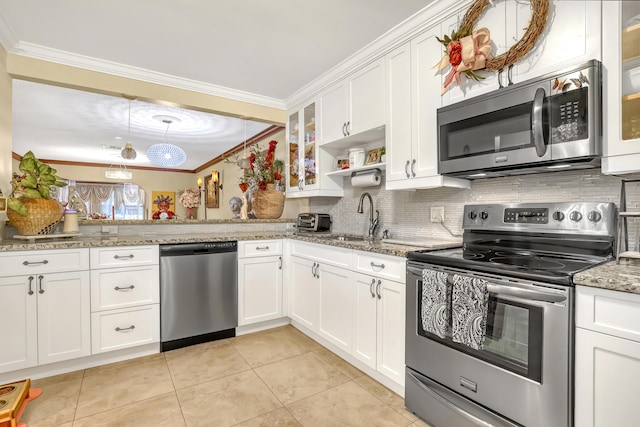 5780 W Fernley Dr Unit 101, West Palm Beach, FL 33415 - kitchen with appliances with stainless steel finishes, a sink, crown molding, tasteful backsplash, and light tile patterned floors